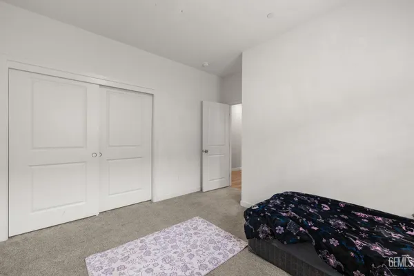 a bathroom with a toilet a sink a mirror and vanity