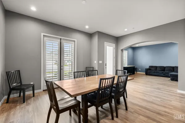 a dining room with furniture and wooden floor