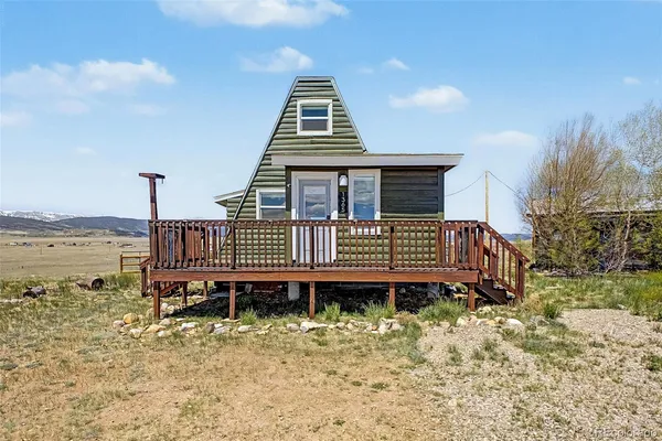 a view of a house with a yard and furniture