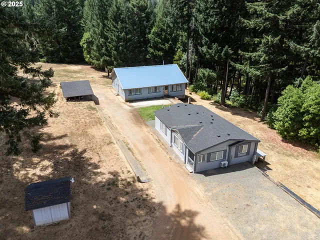 an aerial view of a house with a yard
