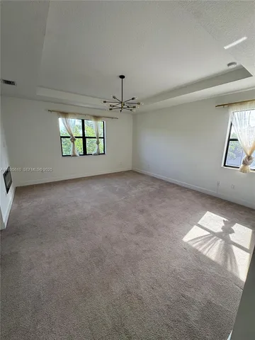 a view of a room with a ceiling fan