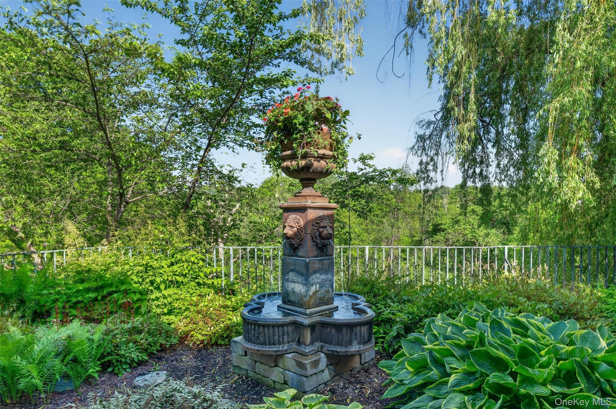 165 Hasbrouck Road Goshen, NY 10924 - Photo 40 of 50 Mature gardens graced with statues, urns and water features are displayed throughout the property. All urns and planters have automatic drip watering systems.