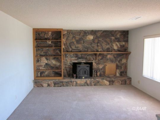 2127 West Ridgecrest Boulevard Ridgecrest, CA 93555 - Photo 5 of 30 an empty room with a fireplace