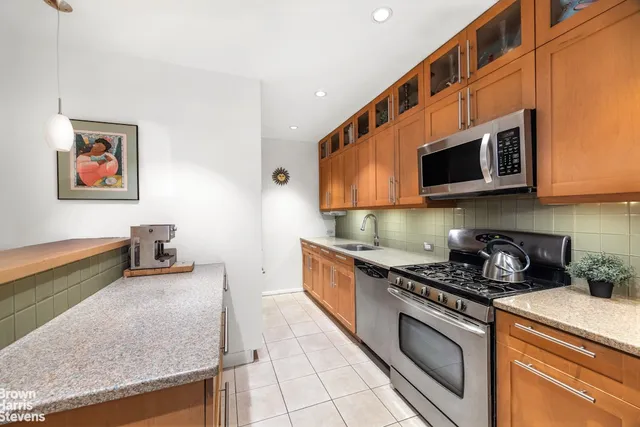 a kitchen with stainless steel appliances granite countertop a stove and a microwave