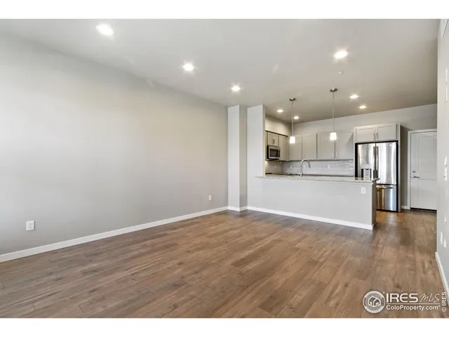 a view of kitchen with refrigerator and window