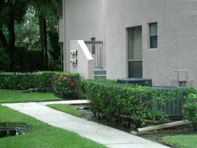 a view of a house with backyard and garden