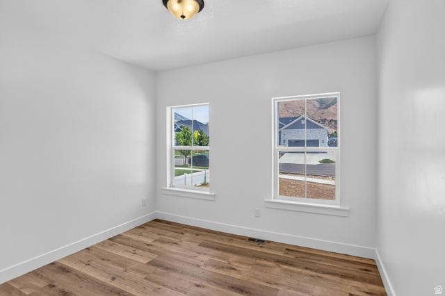 1257 North 1350th Street East Mapleton, UT 84664 - Photo 14 of 31 Room with two windows, wood-finish flooring, white walls, and white trim