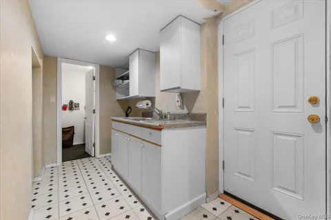 a kitchen with a refrigerator and cabinets