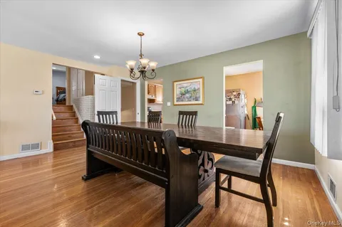 a view of a dining room with furniture wooden floor and chandelier