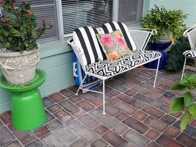 a view of an outdoor sitting area with wooden fence