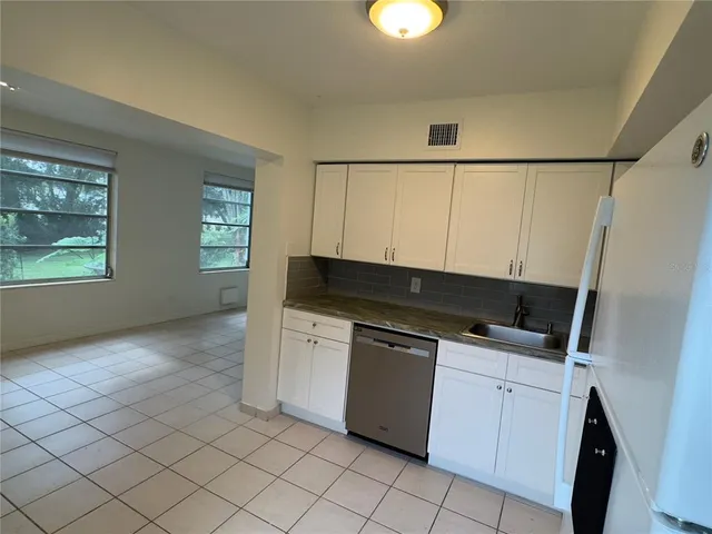 a kitchen with granite countertop a sink and a stove top oven