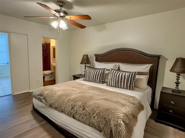a bedroom with a bed and wooden floor