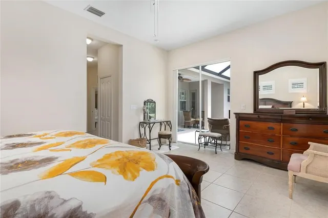 a bedroom with a bed and glass windows