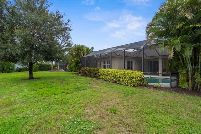 an aerial view of house with yard swimming pool and outdoor seating