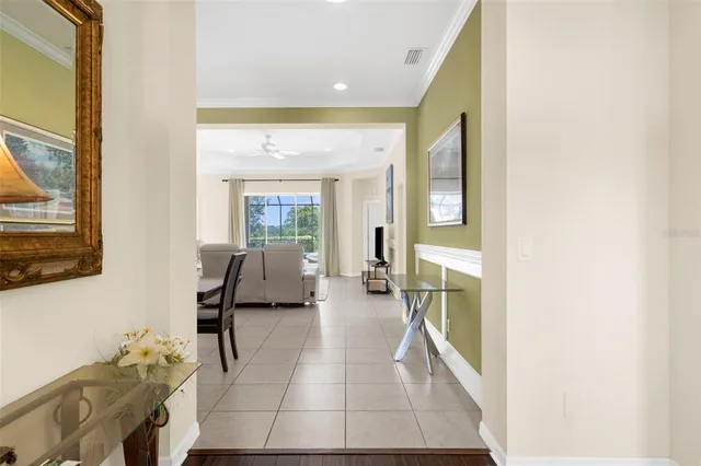 a view of a hallway with wooden floor and a potted plant