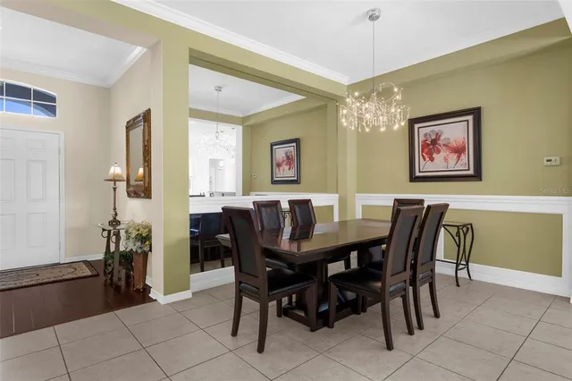 a kitchen with kitchen island granite countertop a stove top oven a sink a dining table and chairs