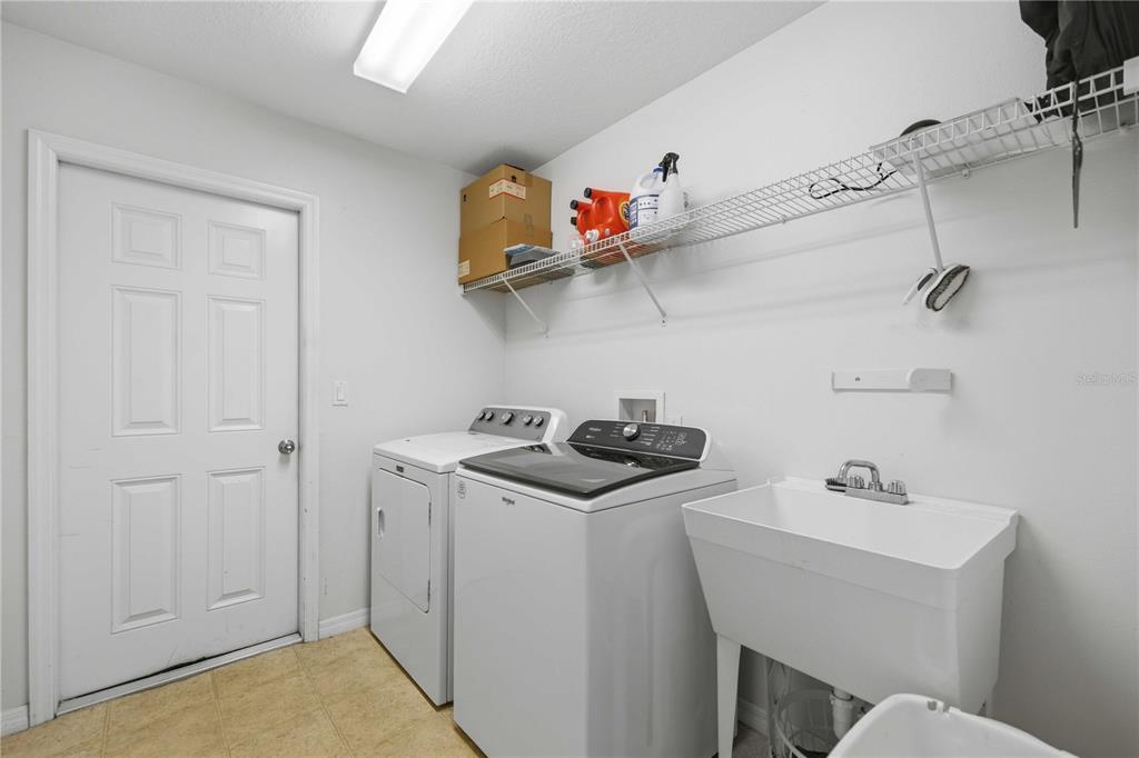 3959 Southwest 129th Street Ocala, FL 34473 - Photo 18 of 27 a bathroom with a sink a stove and cabinets