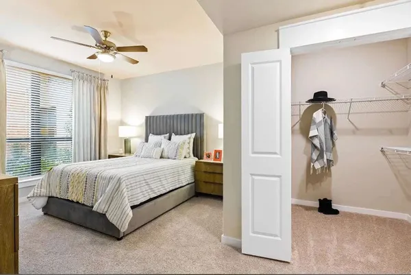 a bedroom with a bed and a ceiling fan