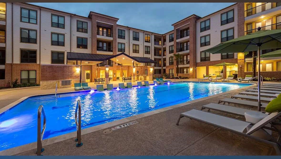 7204 Town Center Boulevard, Unit A2A Rosenberg, TX 77471 - Photo 3 of 12 a view of a building with a swimming pool