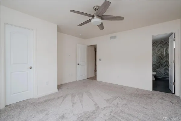 a bathroom with a granite countertop sink a toilet and shower