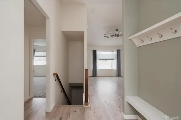 a view of a hallway view with wooden floor and staircase