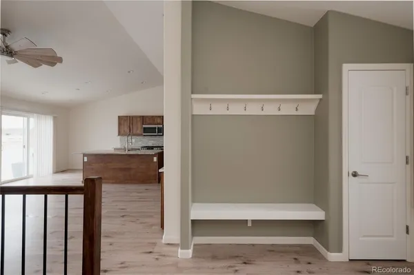a view of kitchen with stainless steel appliances cabinets and a window