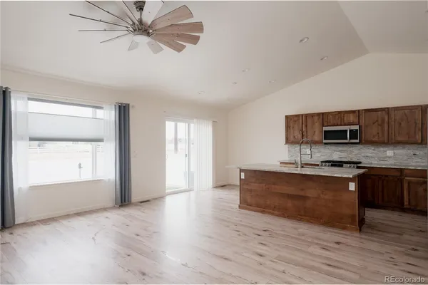 a view of kitchen with sink microwave and stove