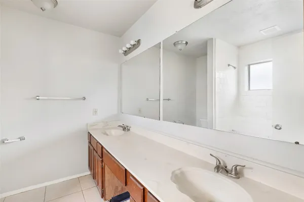 a bathroom with a tub sink and mirror