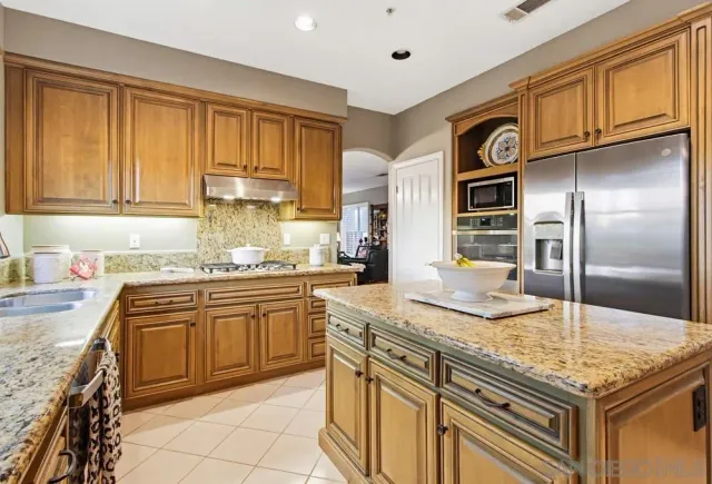 a kitchen with stainless steel appliances granite countertop a sink and cabinets