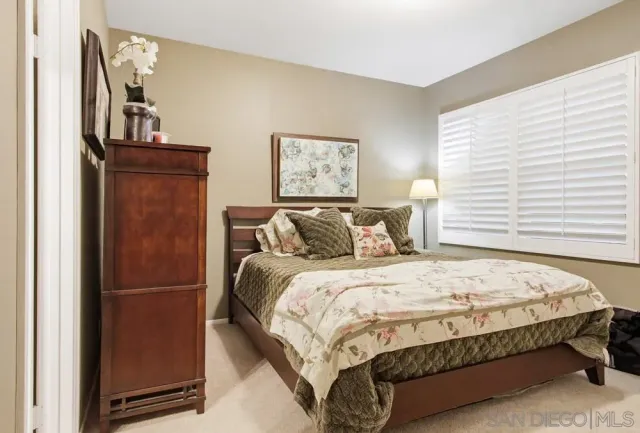 a large bed sitting in a bedroom next to a window
