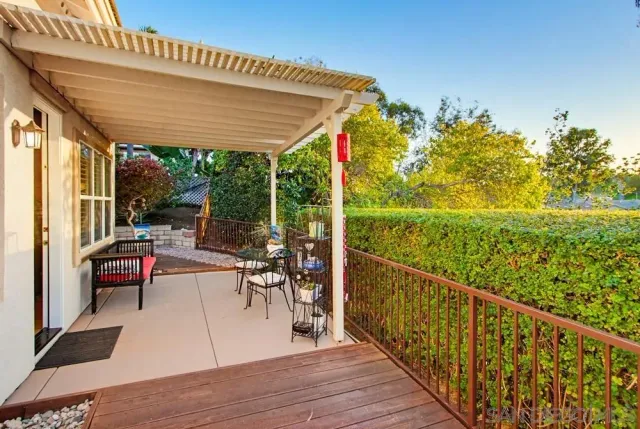 a view of a chairs and table in patio with wooden floor