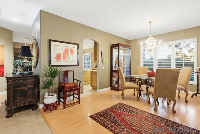 a living room with furniture a dining table and a piano table