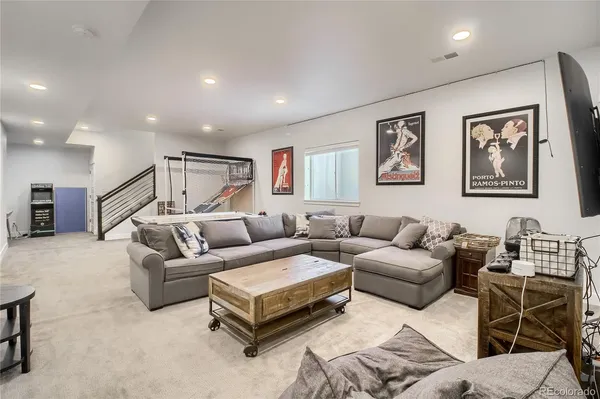 a living room with furniture a couch and painting on the wall