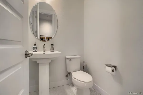 a bathroom with a granite countertop sink toilet a mirror and shower