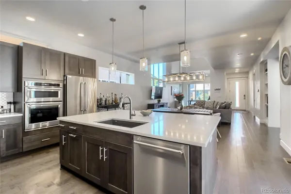 a kitchen with kitchen island a counter top space stainless steel appliances and cabinets