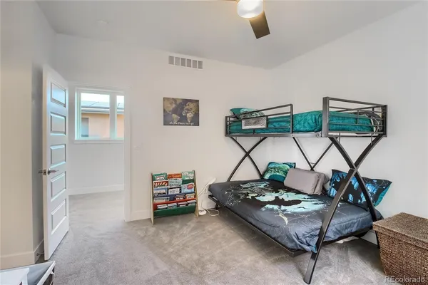a bedroom with a bed and a painting on the wall