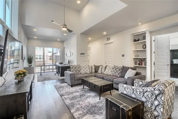 a living room with furniture and wooden floor