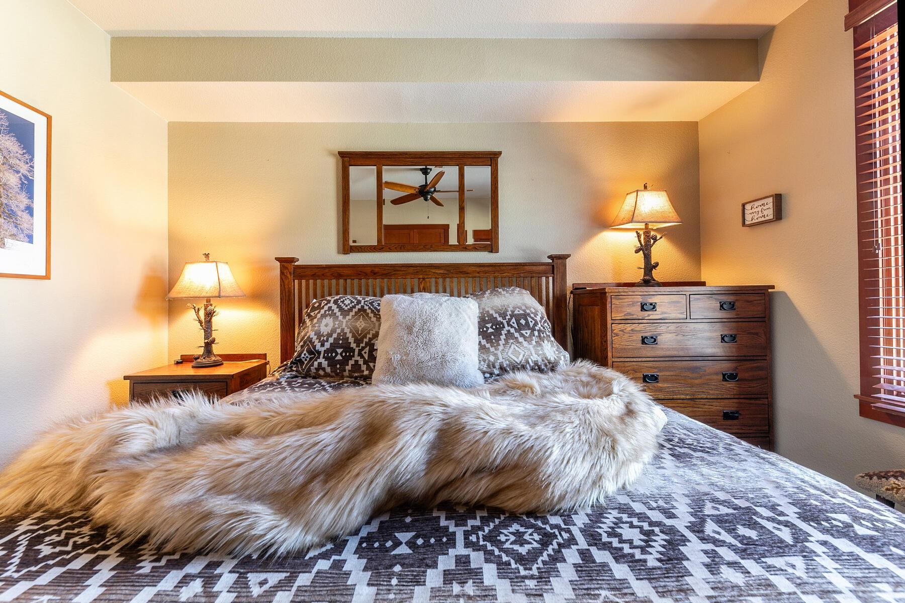 1880 Village South Road, Unit 3334 Olympic Valley, CA 96146 - Photo 22 of 27 a bedroom with a bed and a lamp on dresser