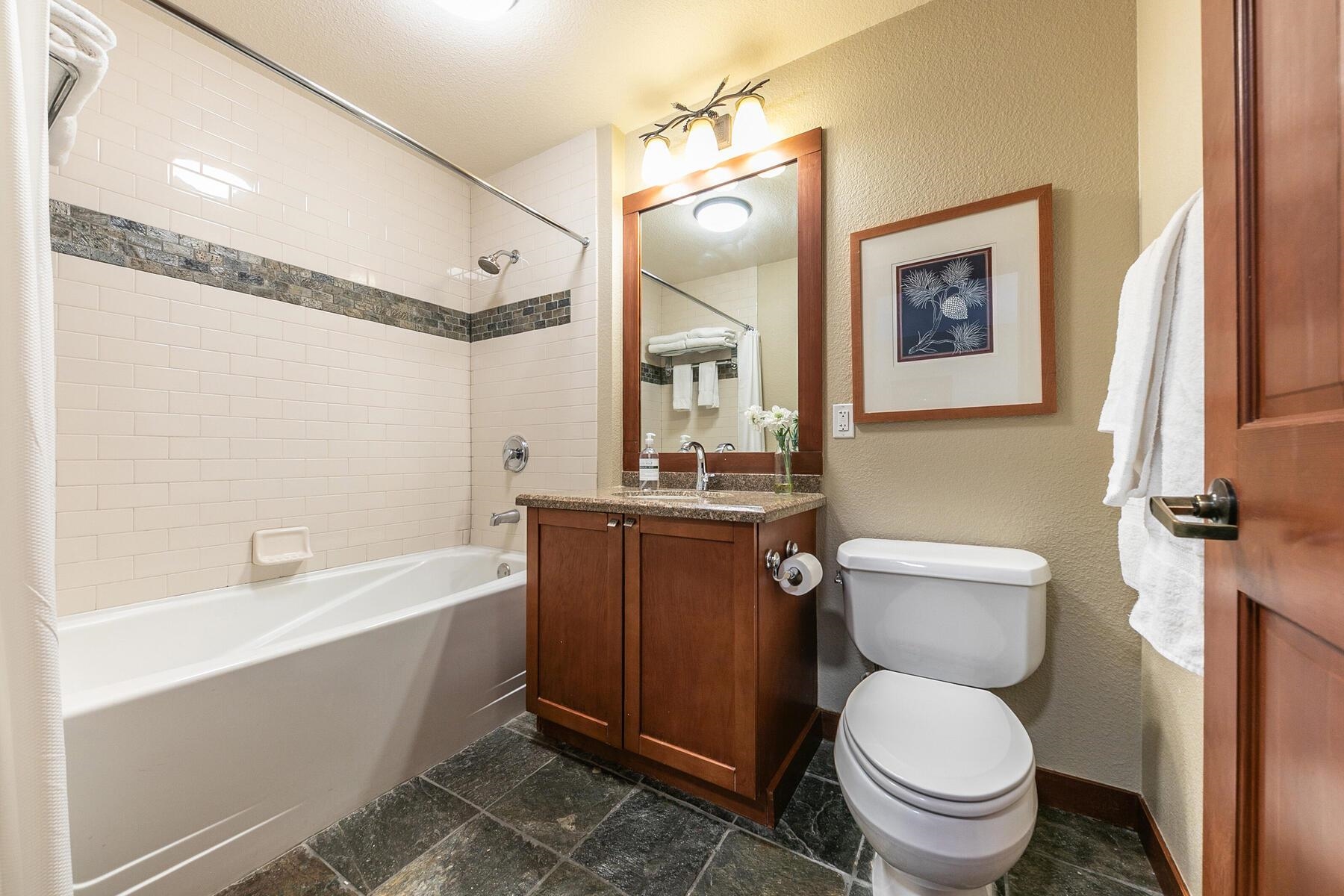 1880 Village South Road, Unit 3334 Olympic Valley, CA 96146 - Photo 23 of 27 a bathroom with a granite countertop toilet a sink and bathtub