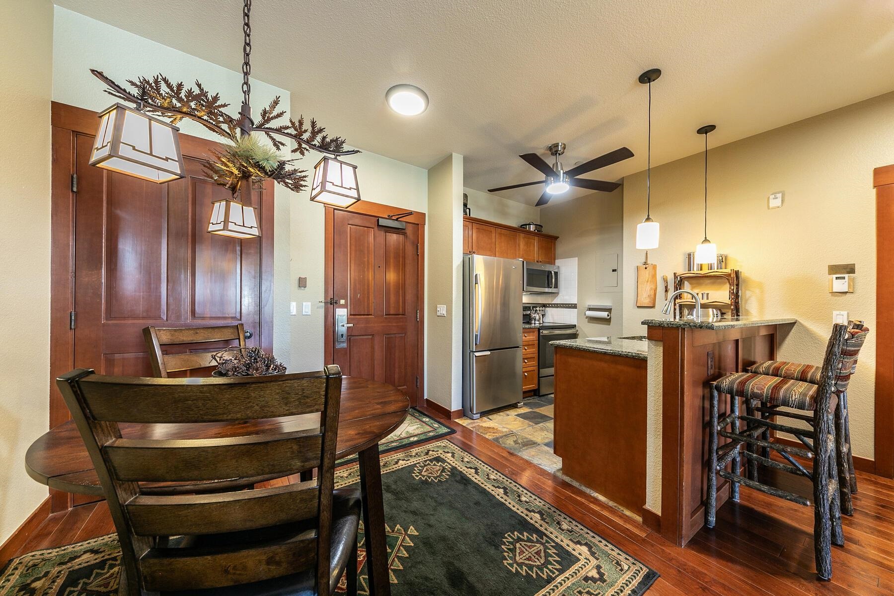 1880 Village South Road, Unit 3334 Olympic Valley, CA 96146 - Photo 7 of 27 a kitchen with granite countertop a refrigerator dining table and chairs