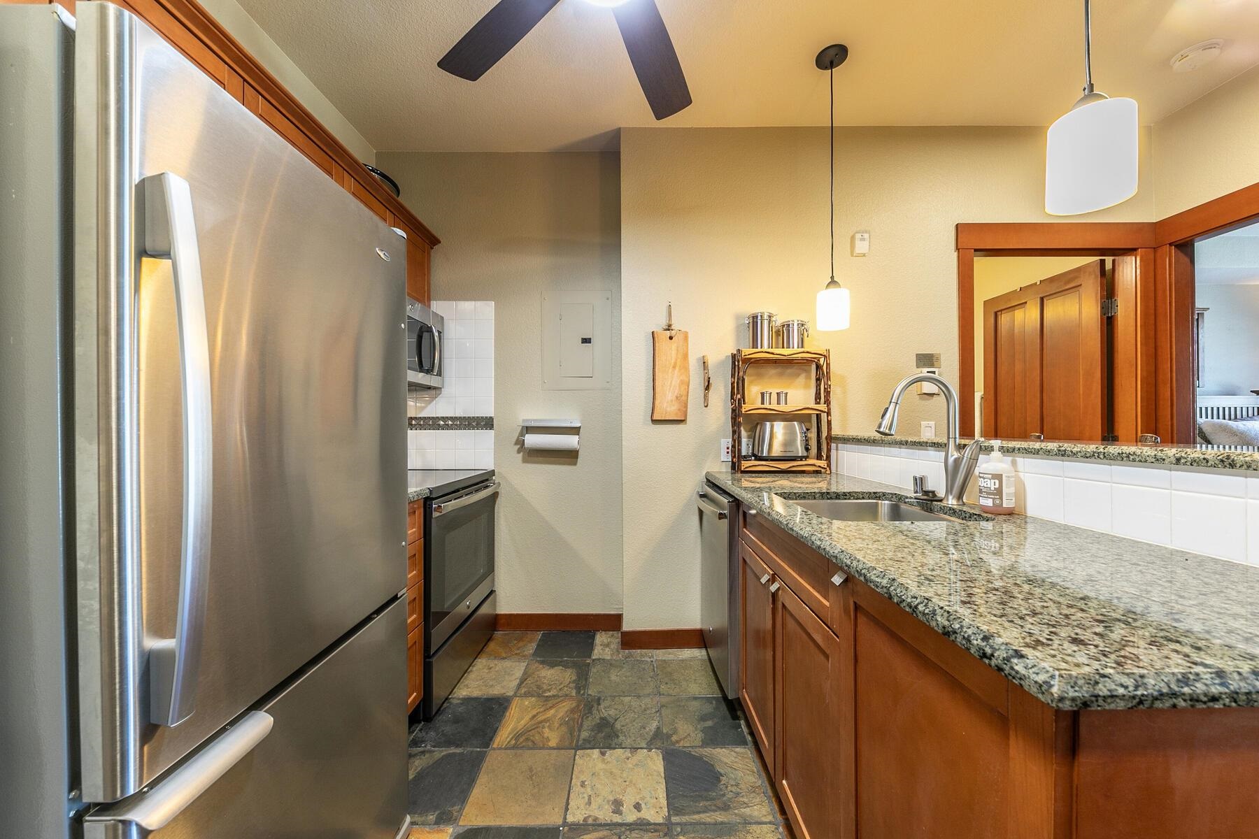 1880 Village South Road, Unit 3334 Olympic Valley, CA 96146 - Photo 8 of 27 a kitchen with stainless steel appliances granite countertop a refrigerator a oven and a sink