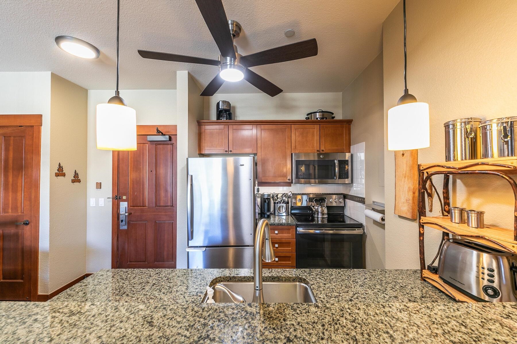 1880 Village South Road, Unit 3334 Olympic Valley, CA 96146 - Photo 9 of 27 a kitchen with stainless steel appliances granite countertop a refrigerator a stove and a sink