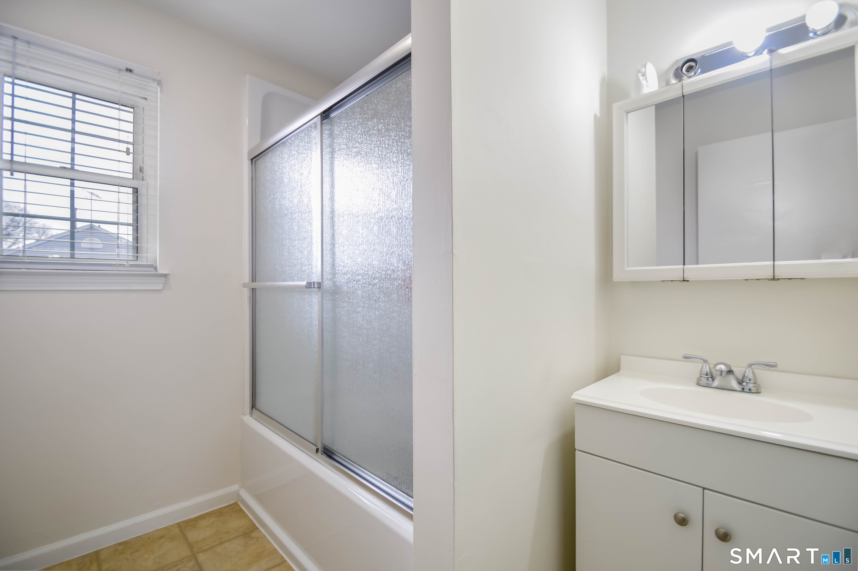 1403 Old Town Road, Unit 1403 Bridgeport, CT 06606 - Photo 11 of 25 a bathroom with a sink and mirror