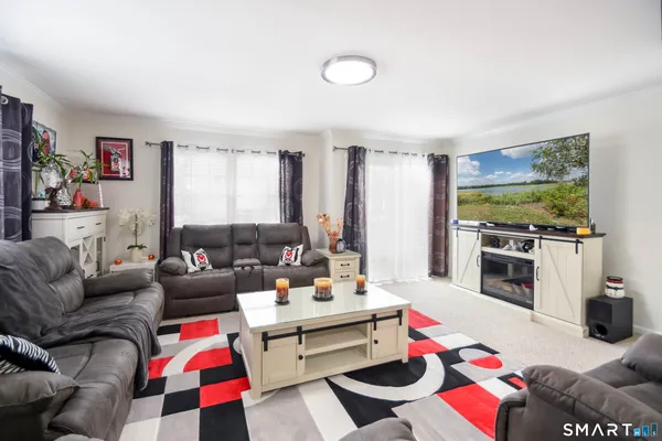 a living room with furniture and a flat screen tv