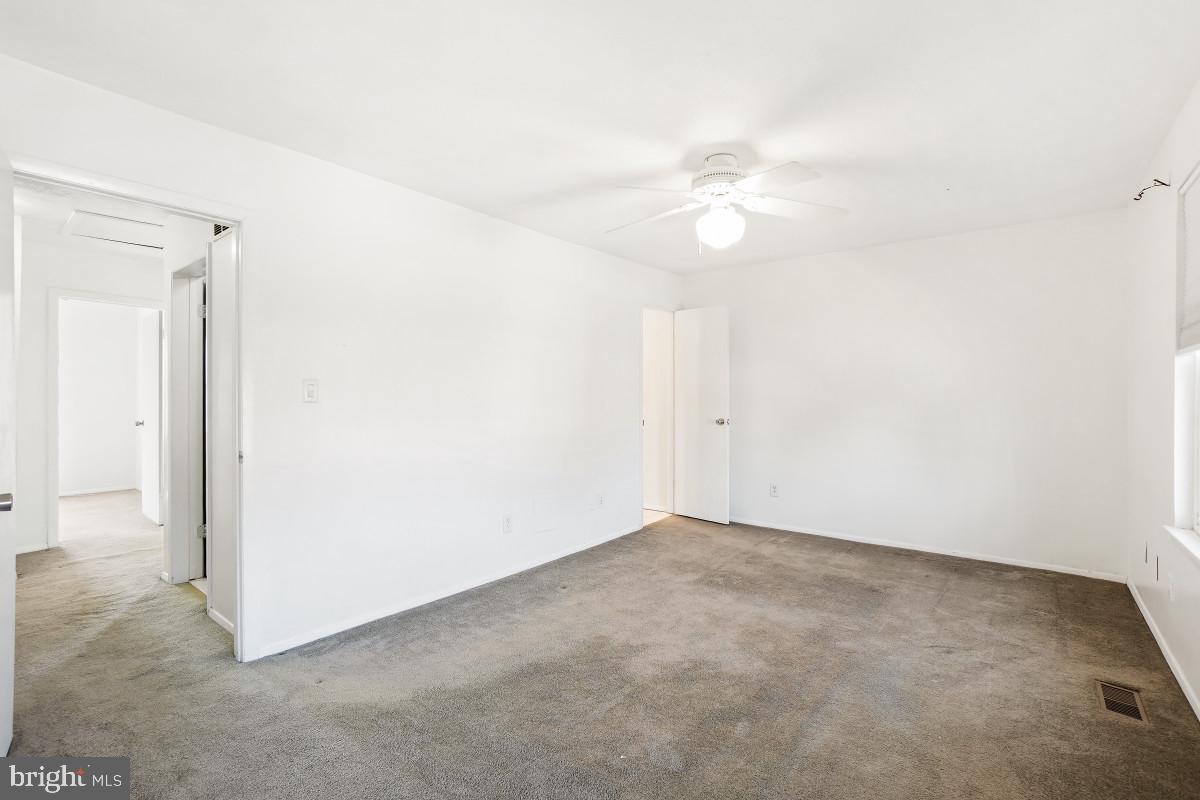 35 Bellfalls Way Nottingham, MD 21236 - Photo 18 of 30 an empty room with a ceiling fan and closet area