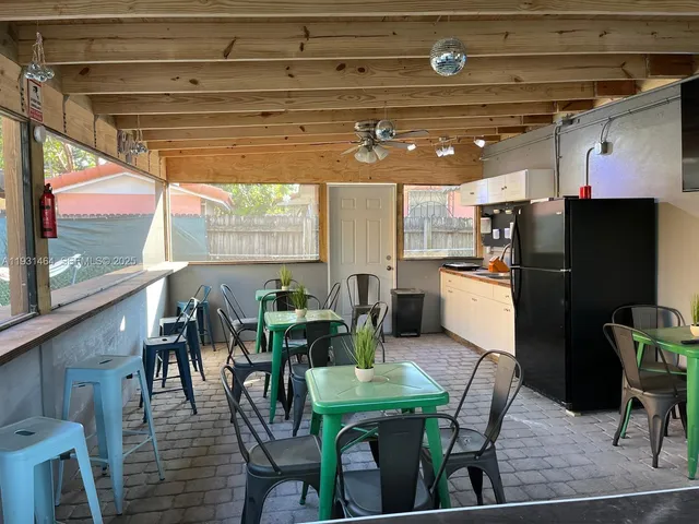 a kitchen with a table chairs refrigerator and cabinets
