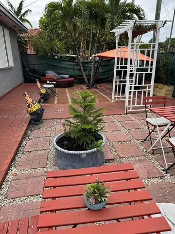 a view of a chairs and table on the patio