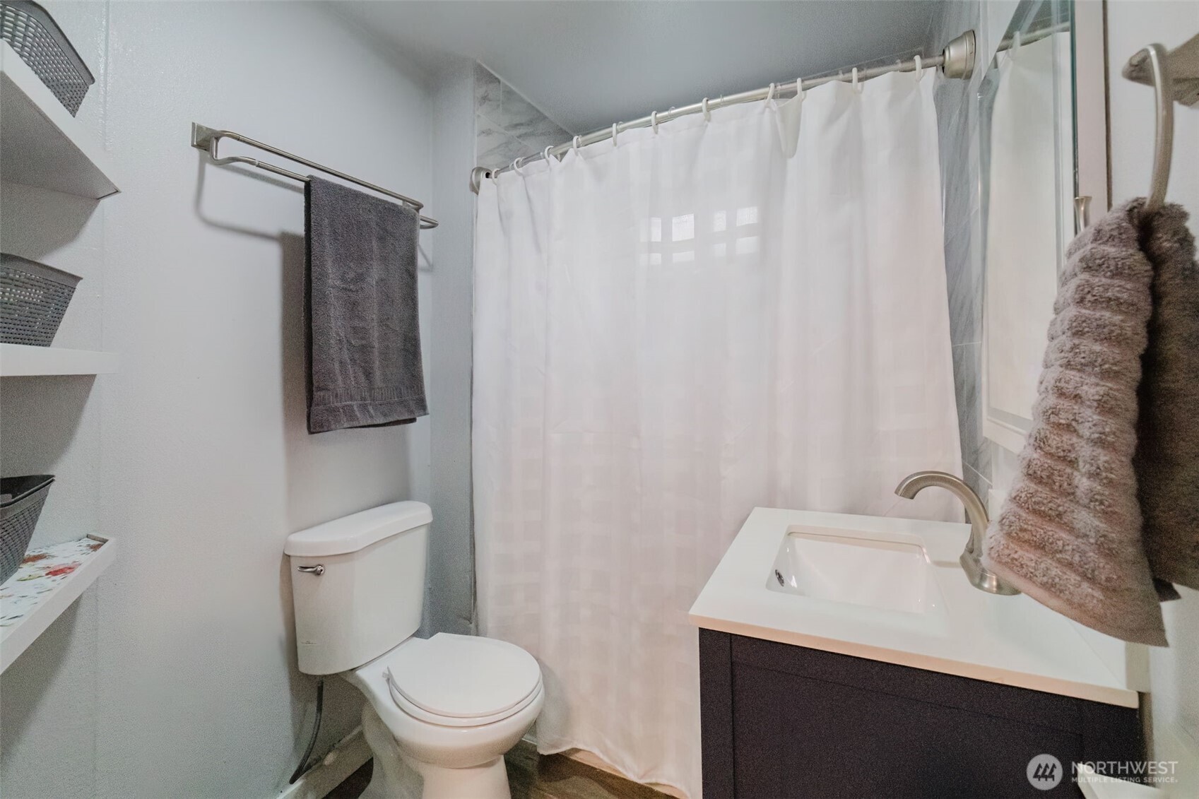 2805 Bowen Street Bremerton, WA 98310 - Photo 23 of 40 a white toilet sitting next to a bathroom sink