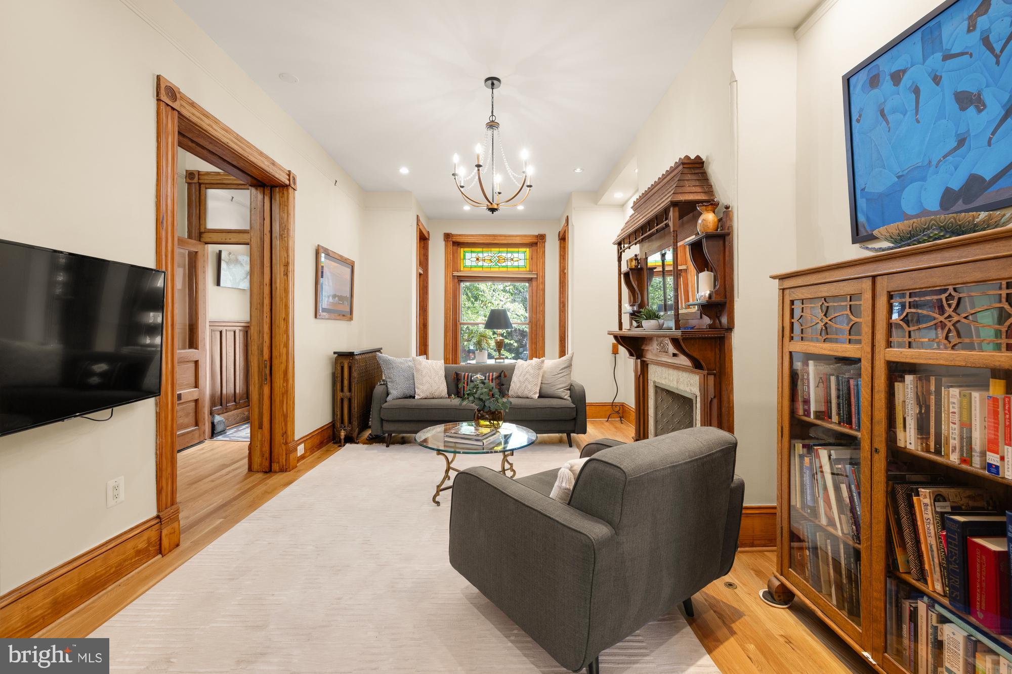 1214 T Street Northwest Washington, DC 20009 - Photo 17 of 88 a living room with furniture a flat screen tv and a book shelf