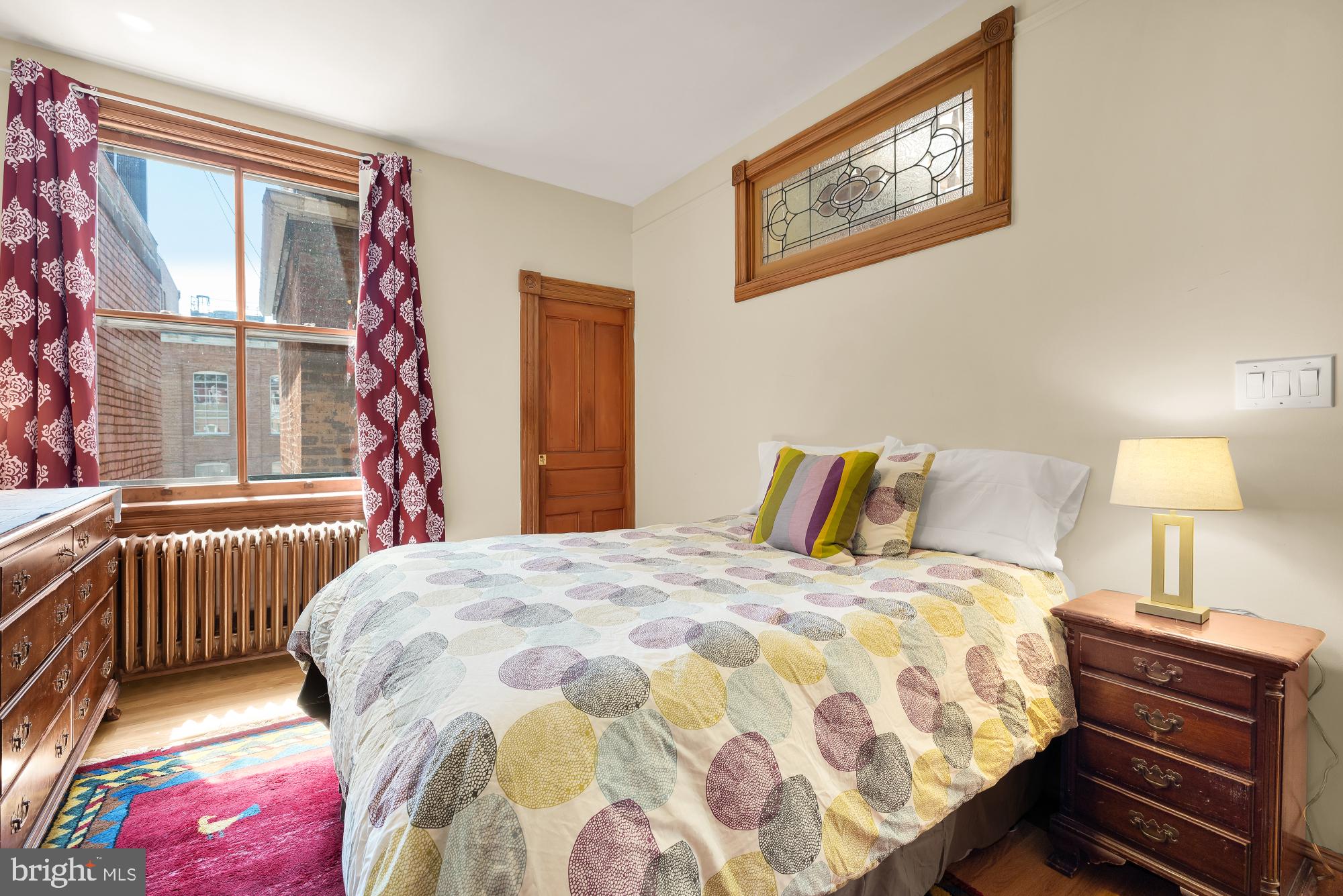 1214 T Street Northwest Washington, DC 20009 - Photo 34 of 88 a bedroom with a bed and a lamp next to a window